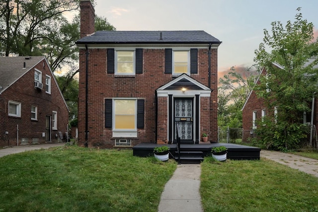 colonial inspired home with a lawn