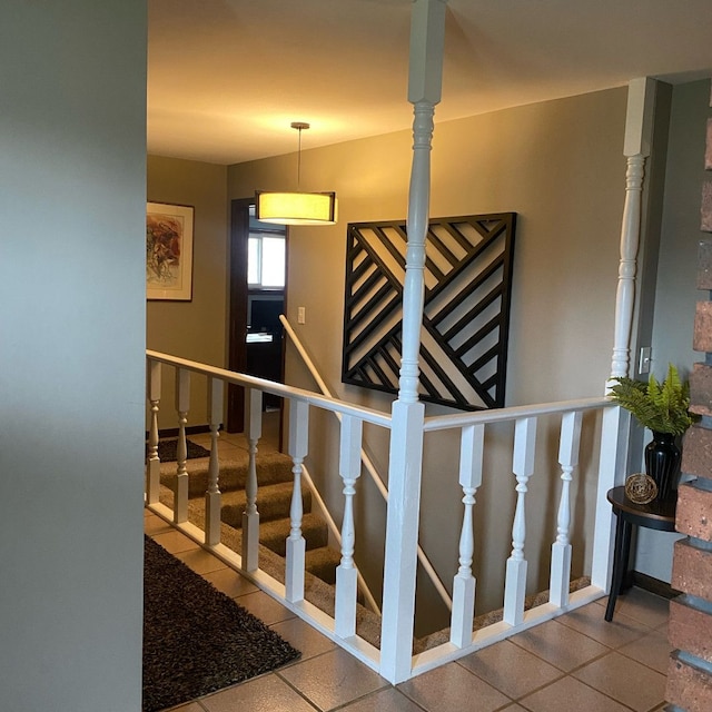 stairway featuring tile patterned flooring