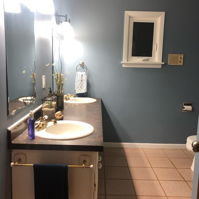 bathroom featuring tile patterned flooring, vanity, and toilet