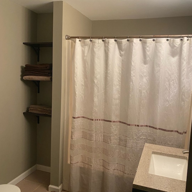 bathroom featuring tile patterned flooring and vanity