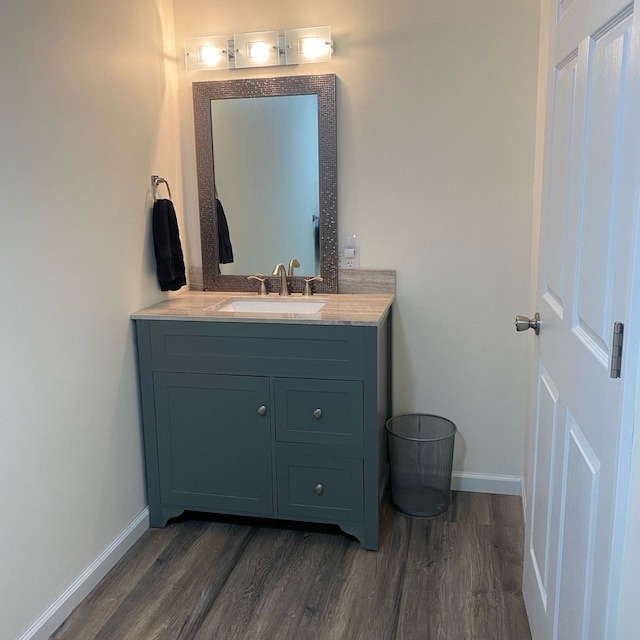 bathroom with hardwood / wood-style flooring and vanity