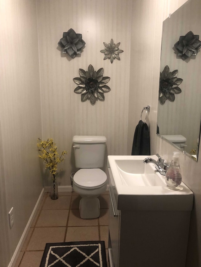 bathroom with tile patterned flooring, vanity, and toilet