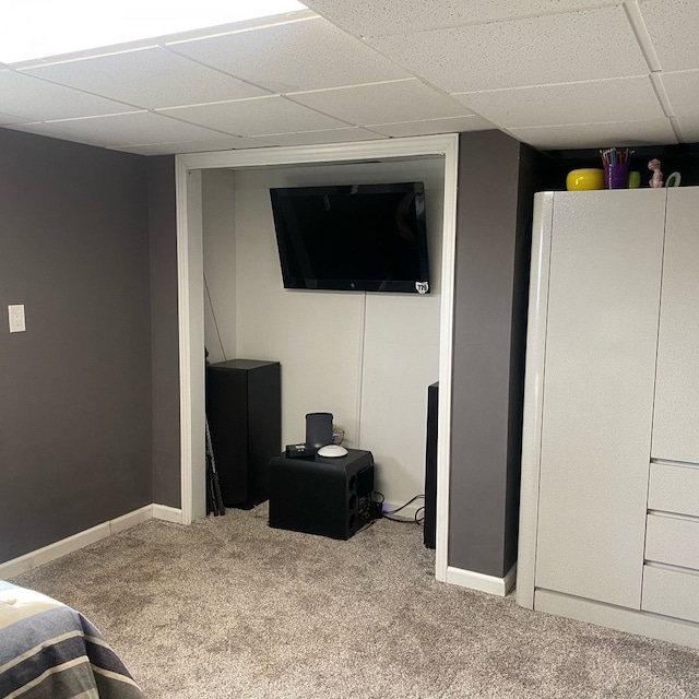 bedroom featuring a paneled ceiling and carpet floors