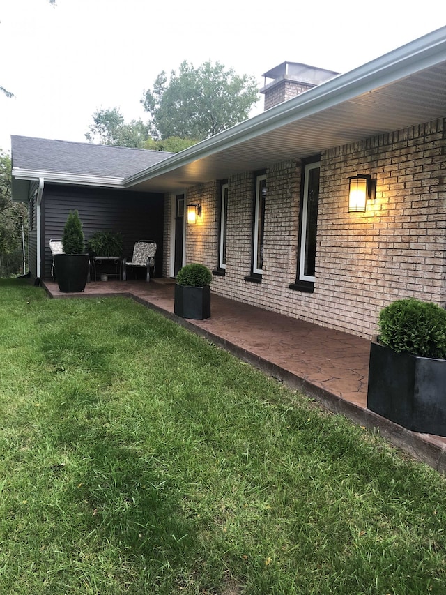 back of house with a yard and a patio area