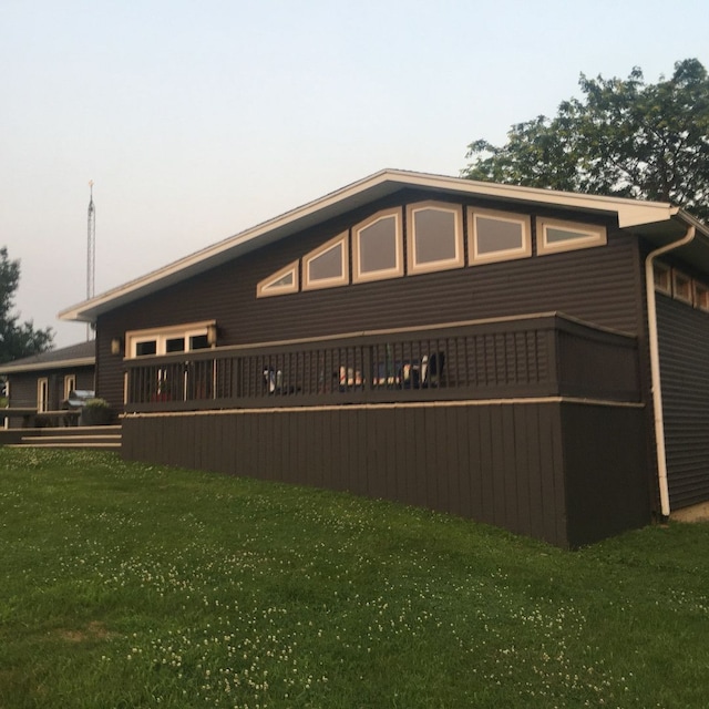 property exterior at dusk with a yard