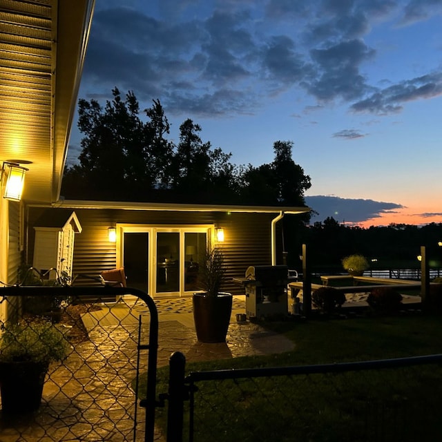 view of back house at dusk