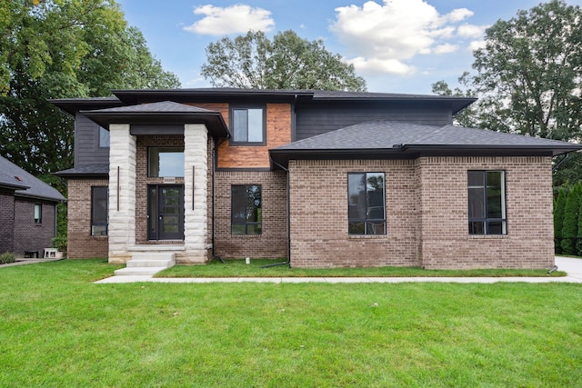 prairie-style home featuring a front lawn