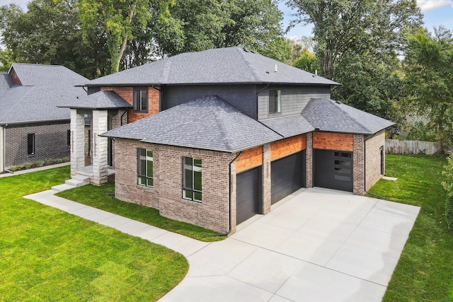 view of front of house with a front yard and a garage