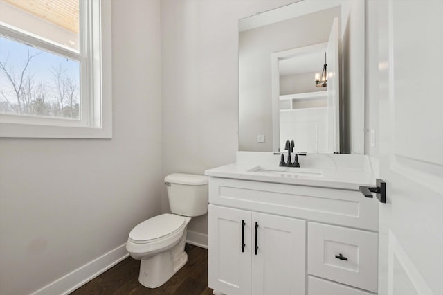 bathroom featuring vanity, toilet, and hardwood / wood-style floors