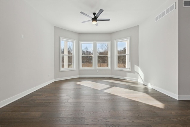 unfurnished room with ceiling fan and dark hardwood / wood-style flooring