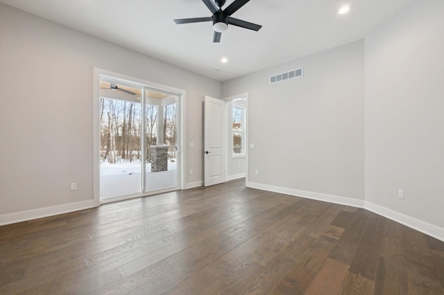 spare room featuring dark wood-type flooring and ceiling fan