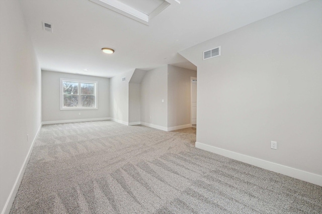 additional living space featuring light carpet