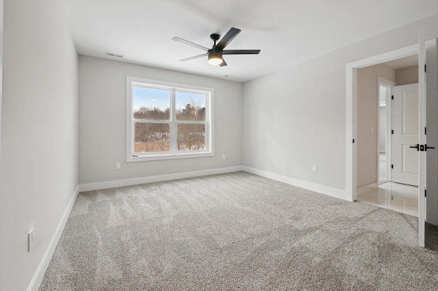 empty room with carpet floors and ceiling fan