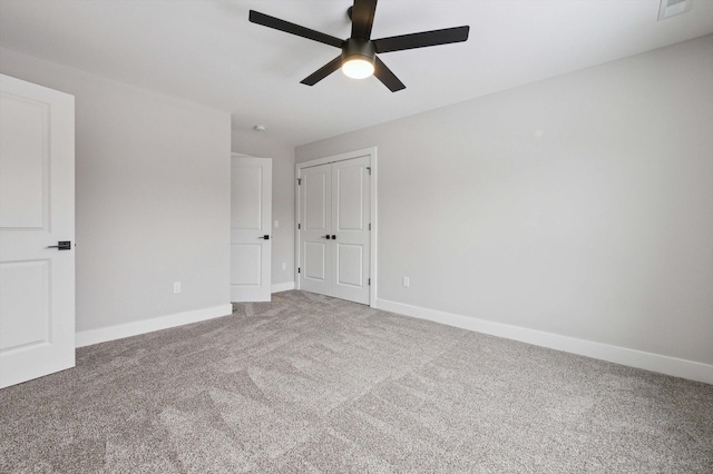 unfurnished bedroom featuring ceiling fan, carpet flooring, and a closet