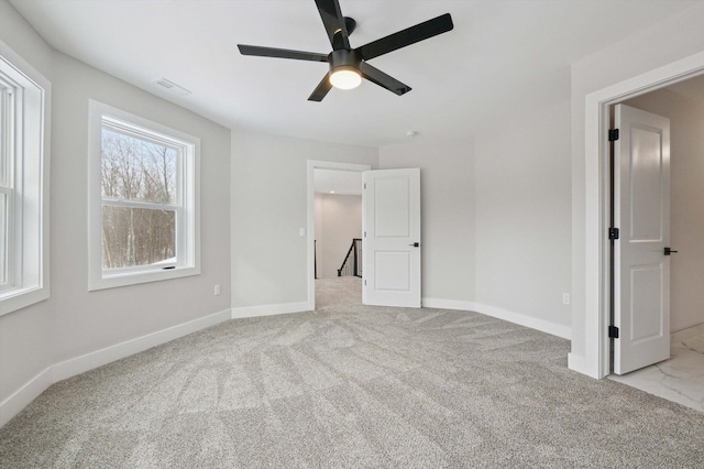 unfurnished bedroom with light colored carpet and ceiling fan