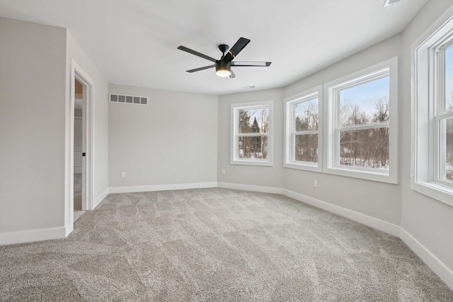 spare room with ceiling fan and carpet flooring