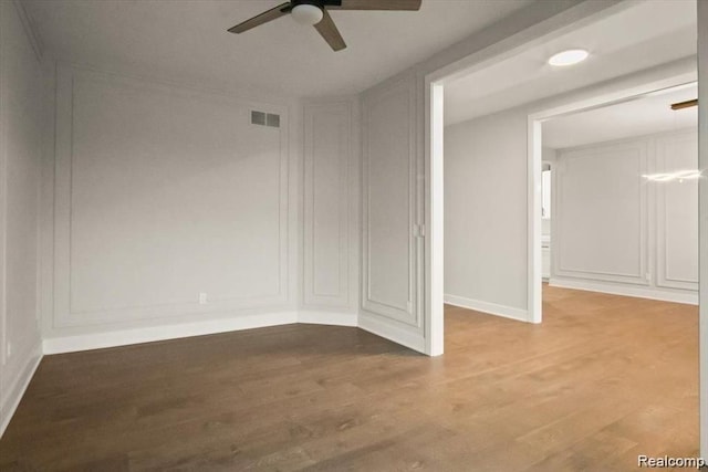 spare room featuring ceiling fan and hardwood / wood-style floors