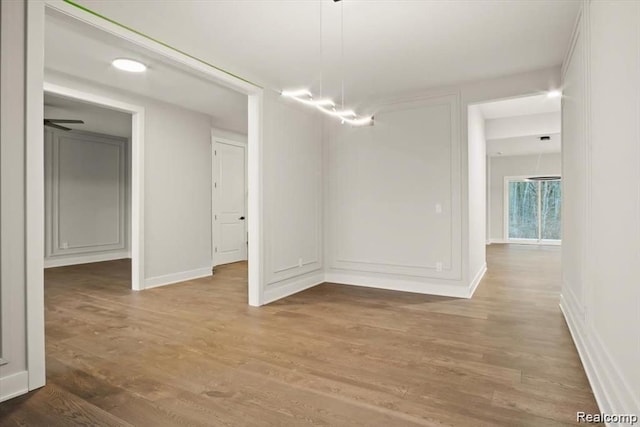 unfurnished dining area featuring hardwood / wood-style floors and ceiling fan