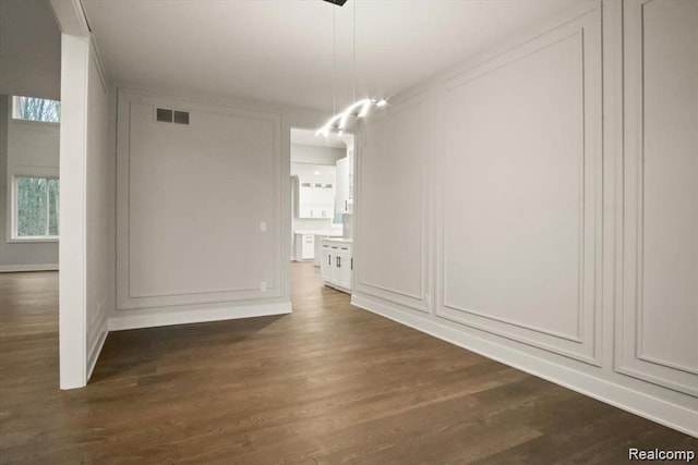 unfurnished dining area with dark hardwood / wood-style floors