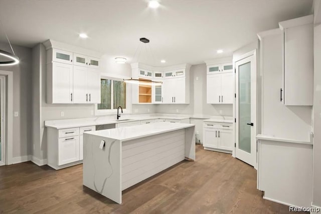 kitchen with a center island, dark hardwood / wood-style floors, white cabinetry, and sink