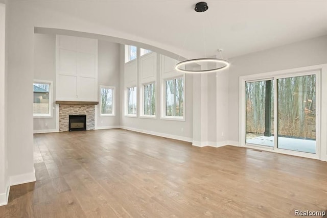 unfurnished living room featuring a fireplace and light wood-type flooring