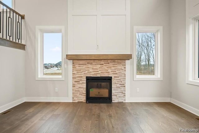 unfurnished living room with a wealth of natural light and hardwood / wood-style flooring