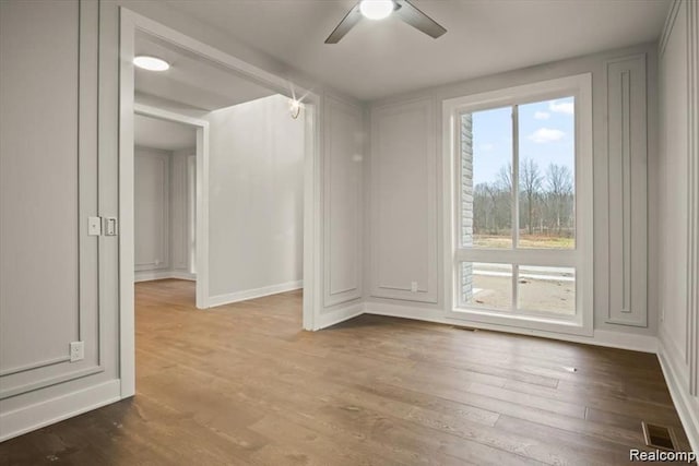 empty room featuring ceiling fan and wood-type flooring