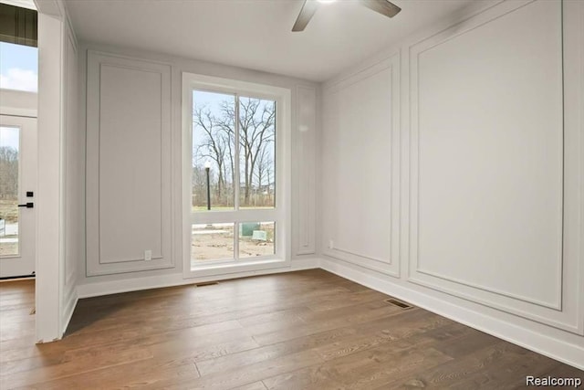 unfurnished room with hardwood / wood-style flooring and ceiling fan