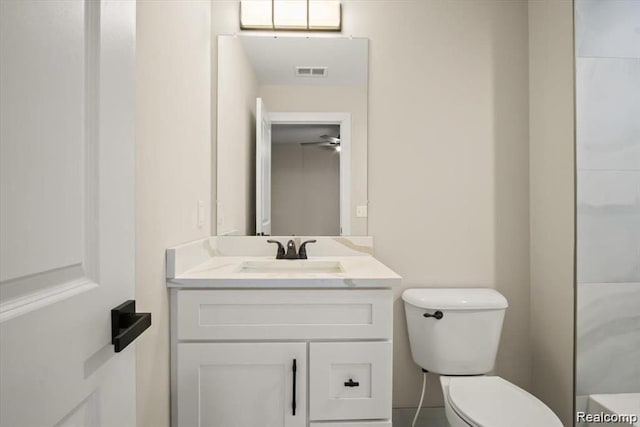 bathroom with vanity, toilet, and ceiling fan