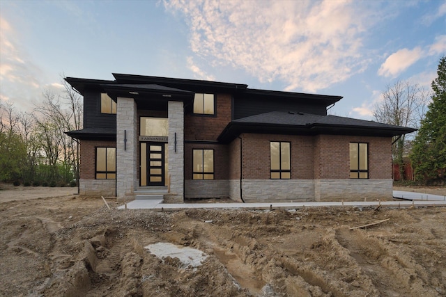 view of front of house featuring brick siding and stone siding
