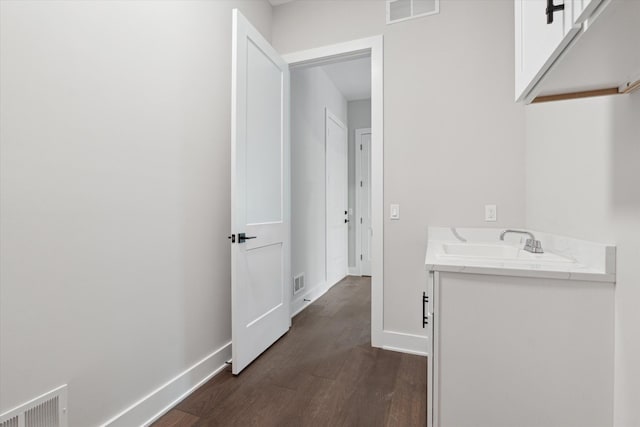 bathroom featuring visible vents, baseboards, and wood finished floors