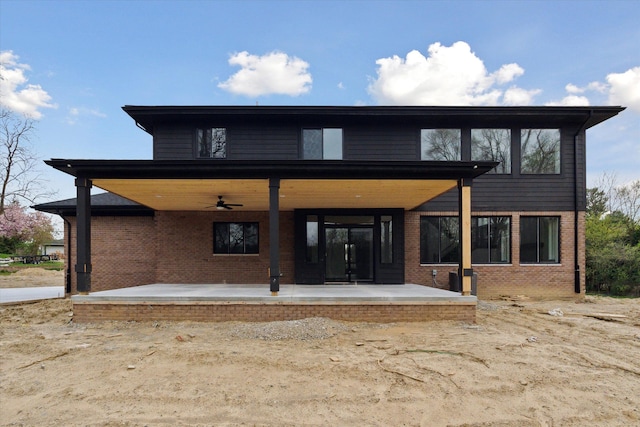 back of property with brick siding and ceiling fan