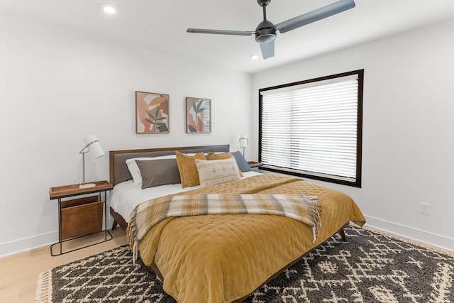 bedroom with light wood-type flooring and ceiling fan