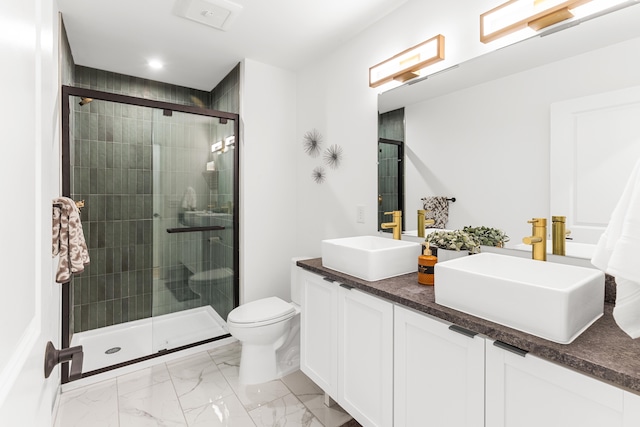 bathroom featuring vanity, toilet, and walk in shower