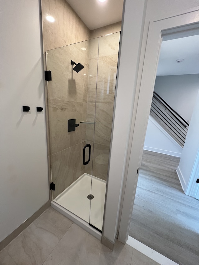 bathroom with a shower with shower door