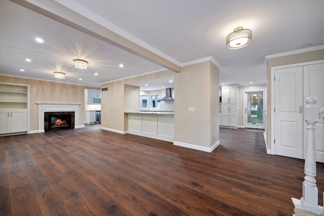 unfurnished living room featuring dark hardwood / wood-style floors, crown molding, and a tile fireplace