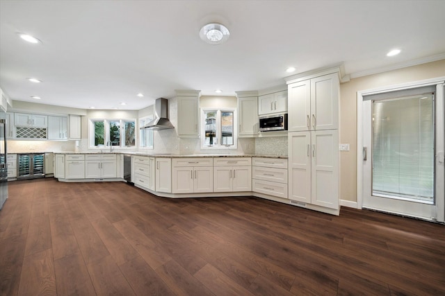 kitchen featuring white cabinets, dark hardwood / wood-style floors, stainless steel microwave, and wall chimney range hood