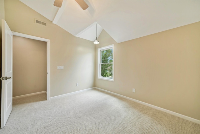 carpeted spare room with vaulted ceiling and ceiling fan