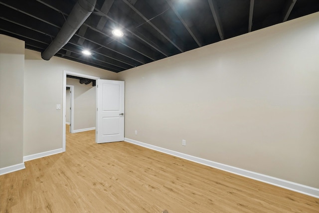 basement with hardwood / wood-style flooring