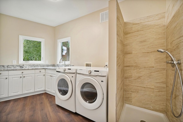 laundry area featuring washer and dryer, dark wood-type flooring, and sink