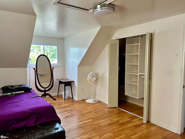 bedroom featuring hardwood / wood-style flooring, a closet, and ceiling fan