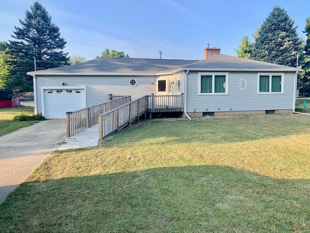 rear view of house featuring a lawn and a garage