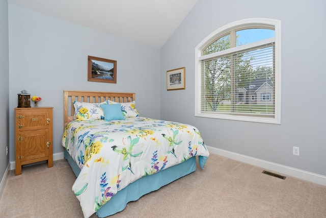 carpeted bedroom featuring lofted ceiling