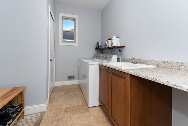 washroom with independent washer and dryer and sink