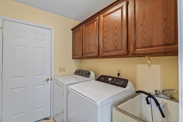 washroom with washing machine and dryer, sink, and cabinets