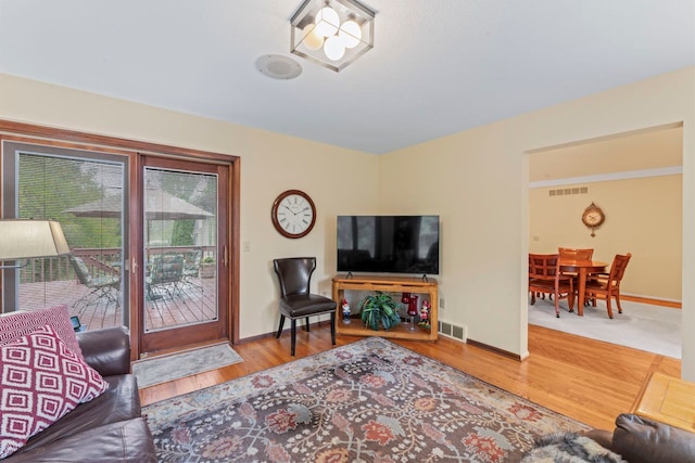 living room featuring hardwood / wood-style flooring and a notable chandelier