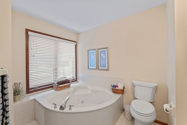 bathroom with tile patterned floors, tiled tub, and toilet