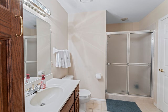 bathroom with vanity, toilet, and a shower with shower door