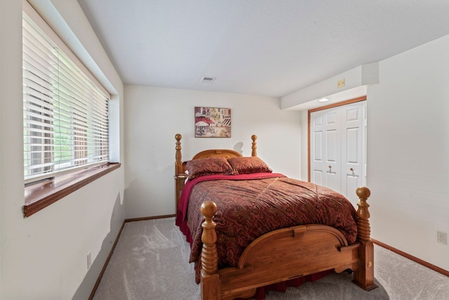 bedroom with a closet and light colored carpet