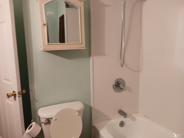 bathroom with shower / bath combination and toilet